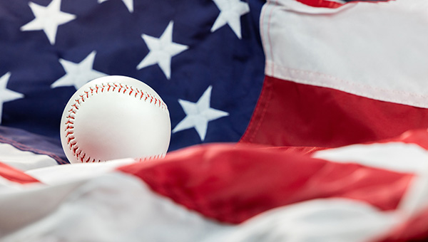 Baseball resting on an American flag.