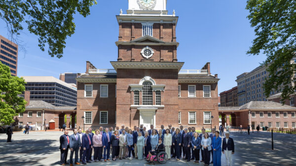 Members of the Pennsylvania State Senate stand in front of Independence Hall.