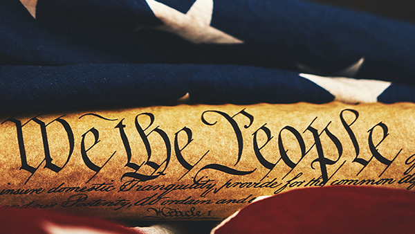 We The People with American flag in background