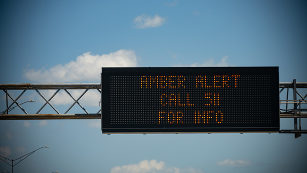 Digital highway sign reading “AMBER ALERT CALL 511 FOR INFO”