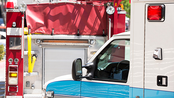Fire truck and EMS ambulance parked outside.