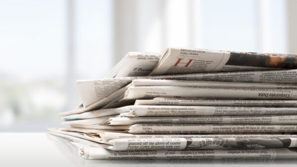 Pile of printed newspapers, close-up view