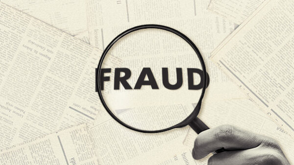 The word FRAUD under a magnified glass.