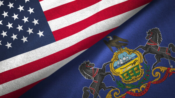 Pennsylvania and United States flags overlapping.