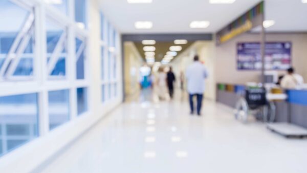 A hospital hallway with bright lighting.