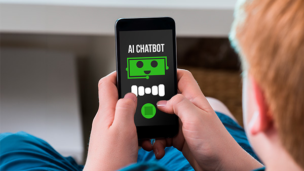 Teenager reading cellphone screen that features the words “AI Chatbot”.